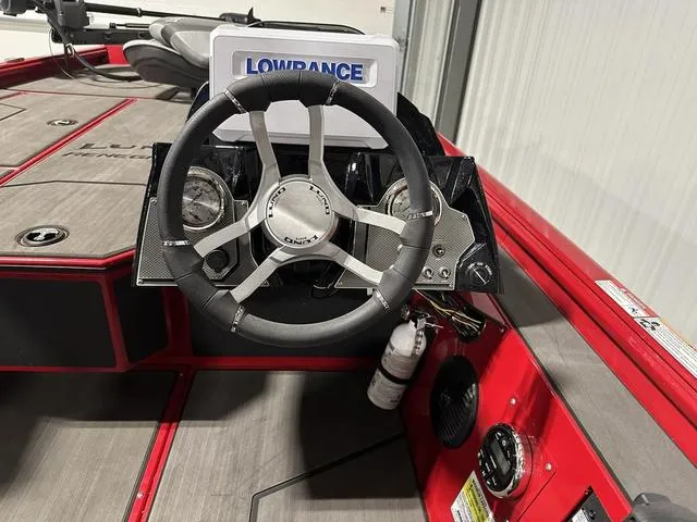 Slide: The Image of 2025 Lund 1875 Renegade SS boat dashboard with Lowrance system and steering wheel. - 16