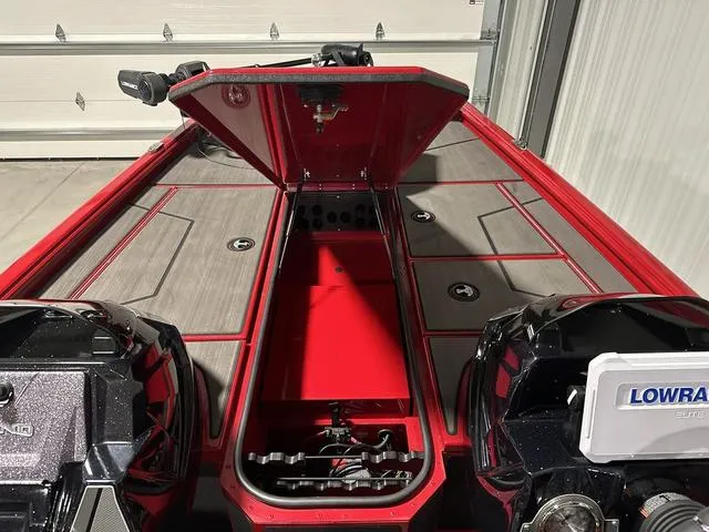 Slide: The Image of 2025 Lund 1875 Renegade SS boat interior with open storage compartment and fishing gear. - 18