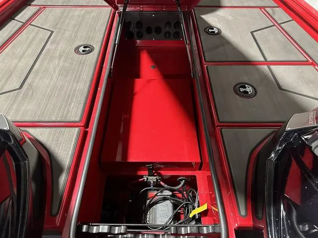 Slide: The Image of 2025 Lund 1875 Renegade SS boat interior with red storage compartments and gray flooring. - 19