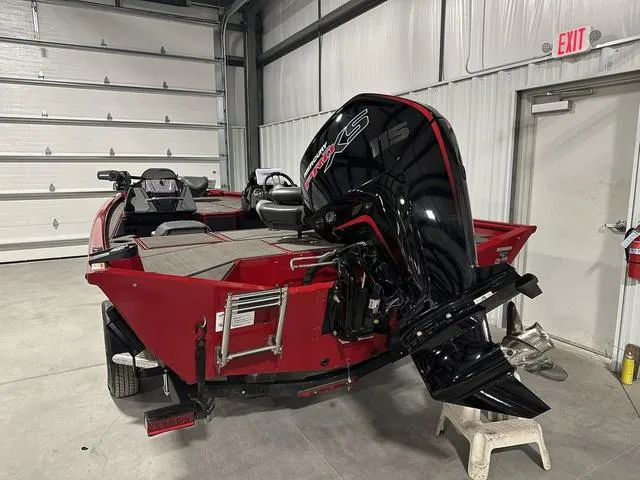 Slide: The Image of 2025 Lund 1875 Renegade SS boat with powerful outboard motor in a garage. - 5