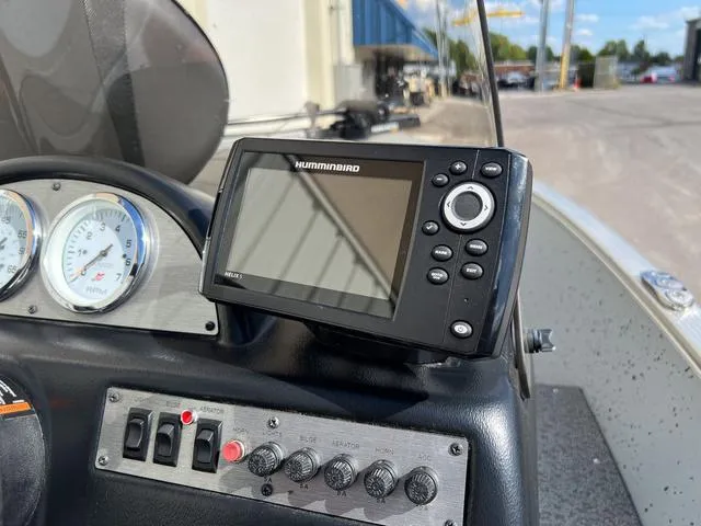 Slide: The Image of 2024 Lund 1600 Fury SS dashboard with Humminbird fish finder and control panel. - 11