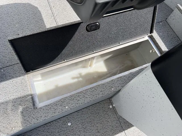 Slide: The Image of 2024 Lund 1600 Fury SS boat storage compartment, open and empty. - 16
