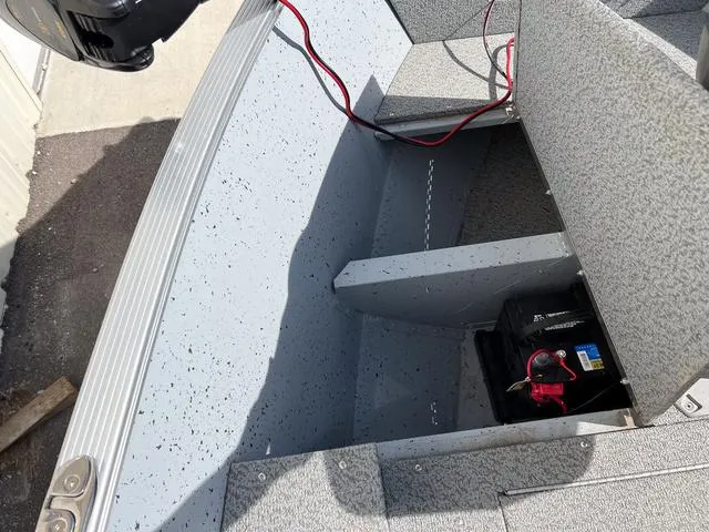 Slide: The Image of 2024 Lund 1600 Fury SS boat interior with battery compartment and wiring. - 17