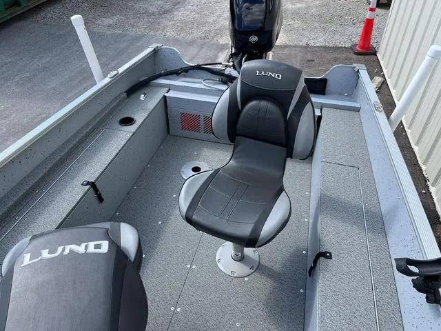 Slide: The Image of 2024 Lund 1600 Fury SS boat interior with swivel seat and motor. - 5