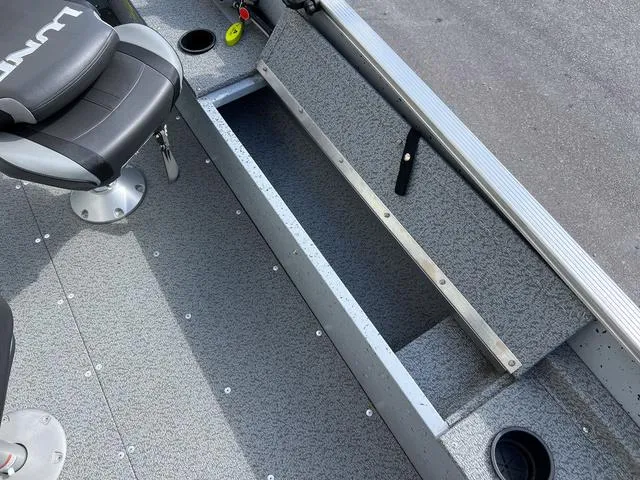 Slide: The Image of 2024 Lund 1600 Fury SS boat interior with storage compartment and seating. - 6