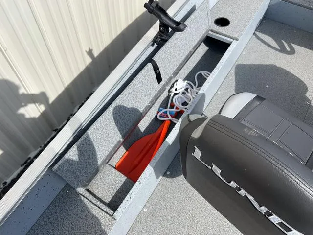 Slide: The Image of 2024 Lund 1600 Fury SS boat interior with storage compartment and seat. - 7