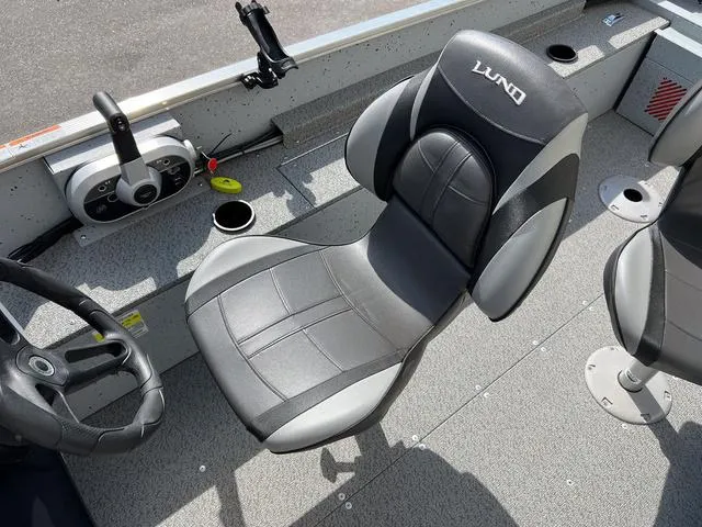 Slide: The Image of 2024 Lund 1600 Fury SS boat interior with steering wheel and comfortable seating. - 8