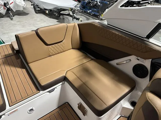 Slide: The Image of 2025 Yamaha Boats 222SD interior with tan leather seating and wood accents. - 10
