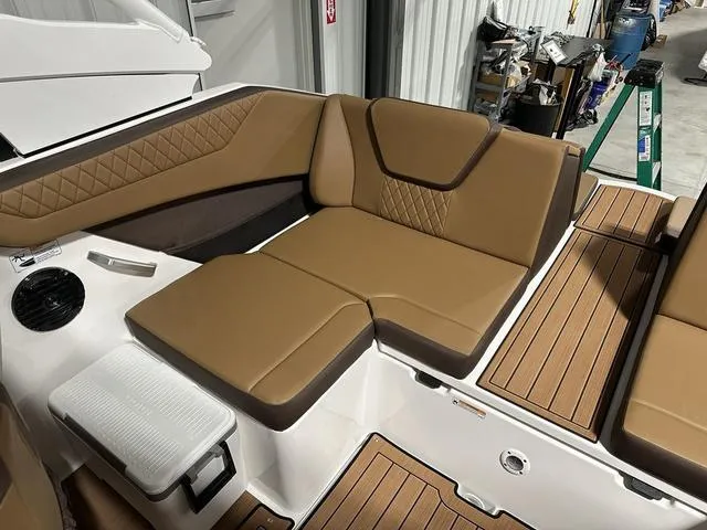 Slide: The Image of 2025 Yamaha Boats 222SD interior with tan seating and wood-style flooring. - 11