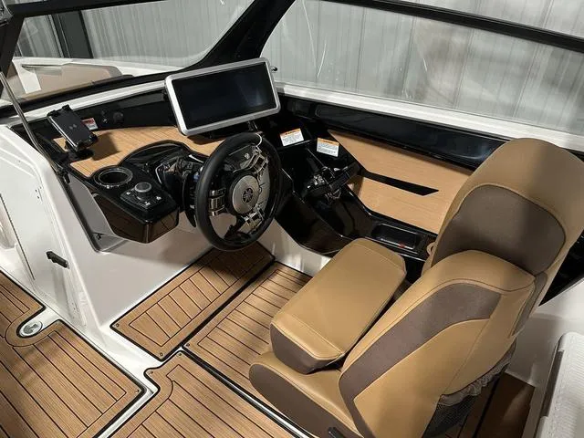 Slide: The Image of 2025 Yamaha Boats 222SD cockpit with modern dashboard and tan seating. - 12