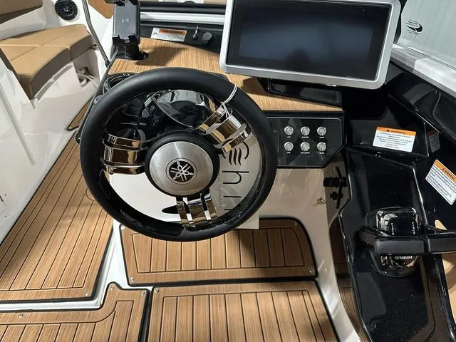 Slide: The Image of 2025 Yamaha Boats 222SD steering wheel and dashboard with wood accents. - 13