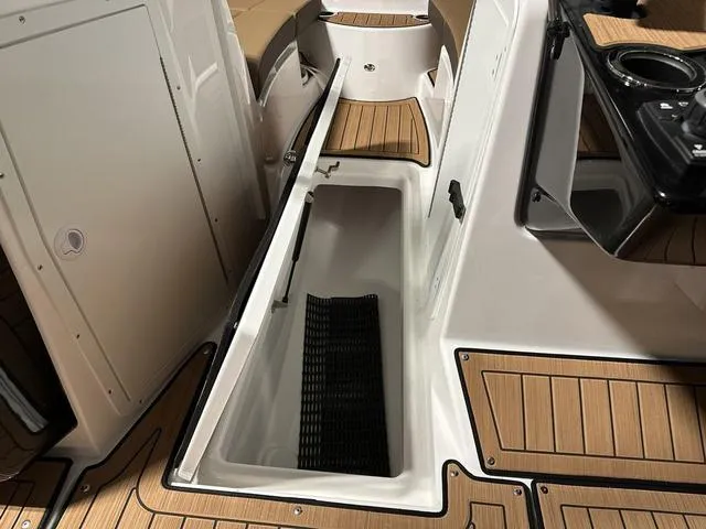 Slide: The Image of 2025 Yamaha Boats 222SD interior storage compartment with teak-style flooring. - 20