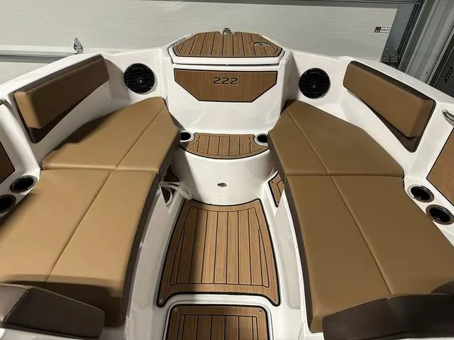Slide: The Image of 2025 Yamaha Boats 222SD interior with tan seating and wood accents. - 21