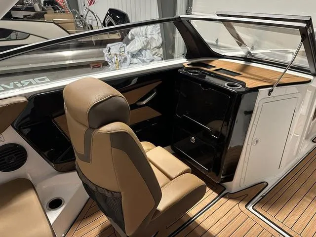 Slide: The Image of 2025 Yamaha Boats 222SD interior with tan seating and sleek dashboard design. - 9