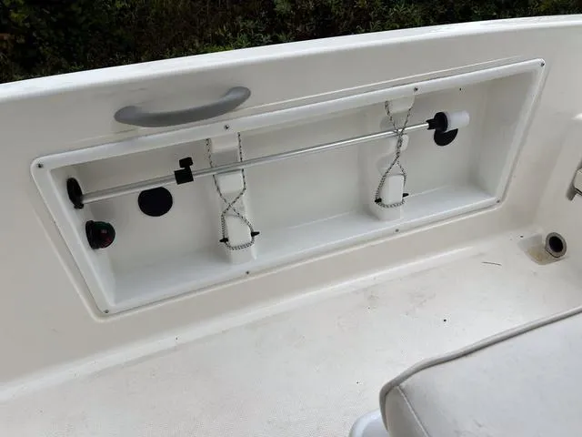 Slide: The Image of 2021 Bayliner T18BAY boat interior storage compartment with rod holders. - 10