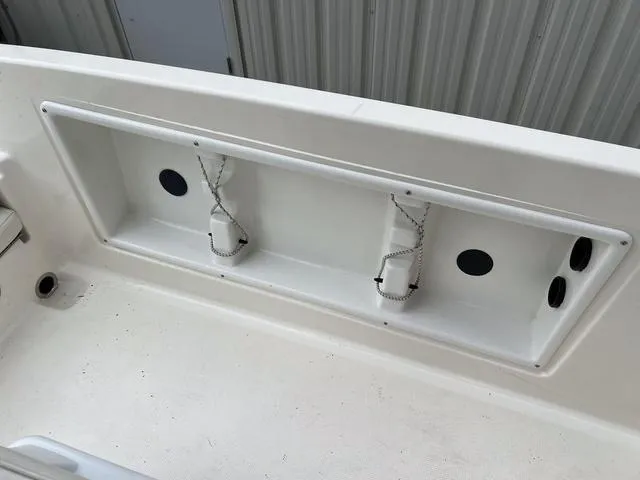 Slide: The Image of 2021 Bayliner T18BAY boat interior storage compartment with rod holders. - 11