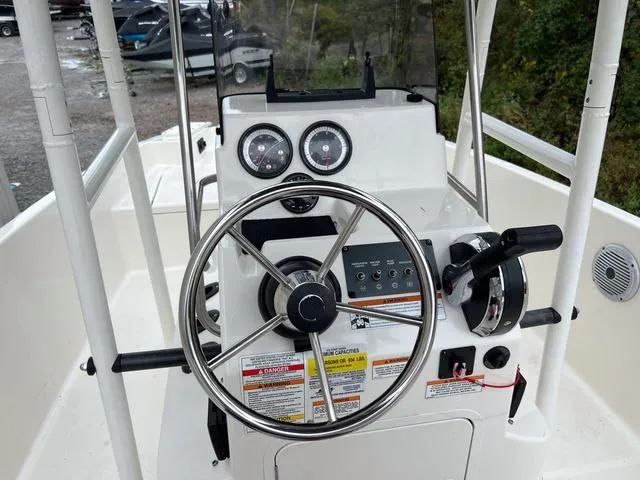 Slide: The Image of 2021 Bayliner T18BAY boat steering console with gauges and controls. - 12