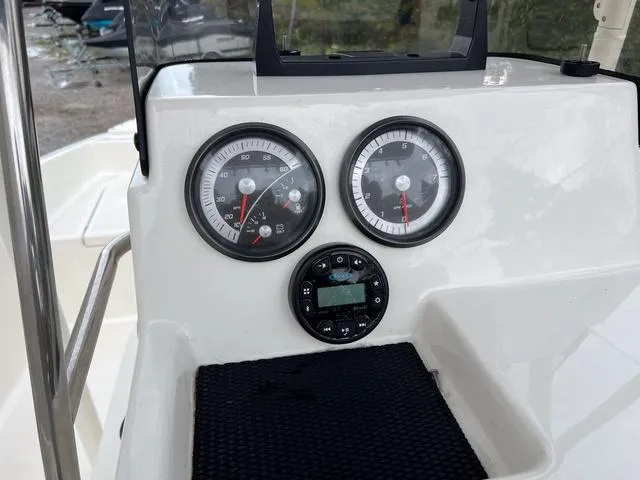 Slide: The Image of Dashboard of 2021 Bayliner T18BAY boat with gauges and controls. - 13