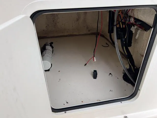 Slide: The Image of 2021 Bayliner T18BAY storage compartment with wiring and equipment. - 15