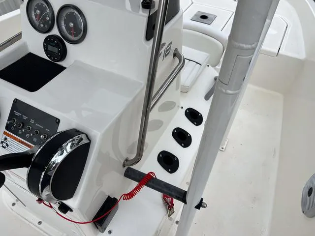 Slide: The Image of 2021 Bayliner T18BAY boat dashboard with steering wheel and gauges. - 16