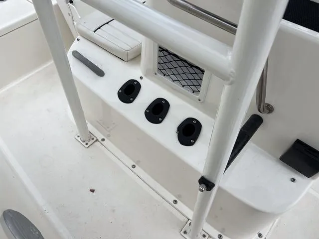 Slide: The Image of 2021 Bayliner T18BAY boat interior with rod holders and storage compartments. - 17