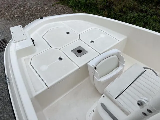 Slide: The Image of 2021 Bayliner T18BAY boat deck with storage compartments and seating. - 18