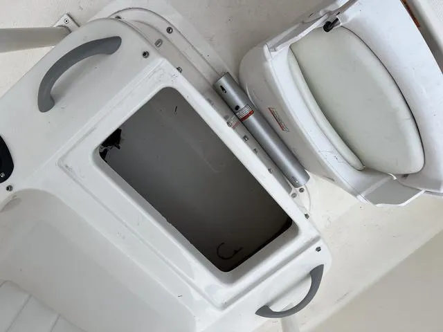 Slide: The Image of 2021 Bayliner T18BAY boat interior with storage compartment and seating. - 19