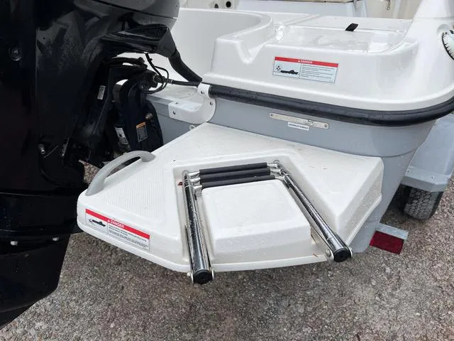 Slide: The Image of 2021 Bayliner T18BAY boat with foldable swim ladder and outboard motor. - 5