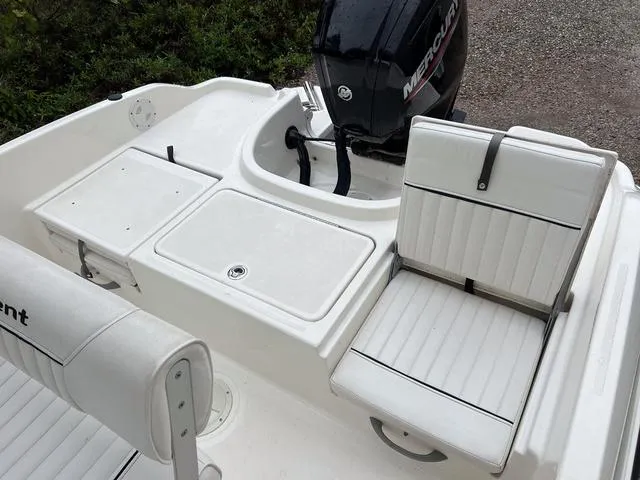 Slide: The Image of 2021 Bayliner T18BAY boat interior with Mercury engine and white seating. - 6