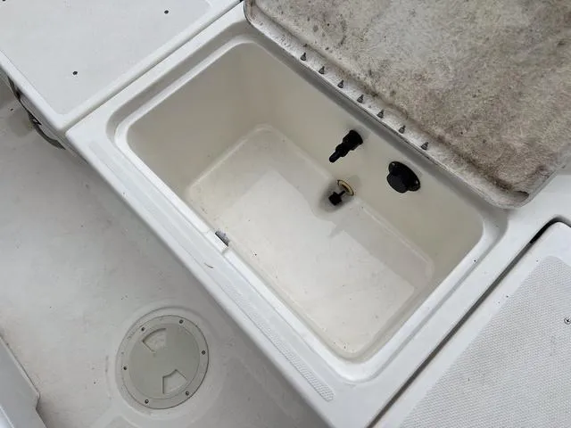 Slide: The Image of 2021 Bayliner T18BAY boat storage compartment with open lid. - 7