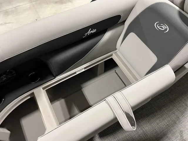 Slide: The Image of 2025 Barletta Aria A24QC boat interior with storage compartment and seating. - 10