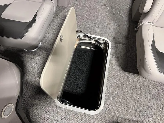 Slide: The Image of Barletta Aria A24QC 2025 boat interior storage compartment with open lid. - 12