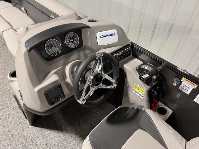 Slide: The Image of 2025 Barletta Aria A24QC boat dashboard with steering wheel and control panel. - 13