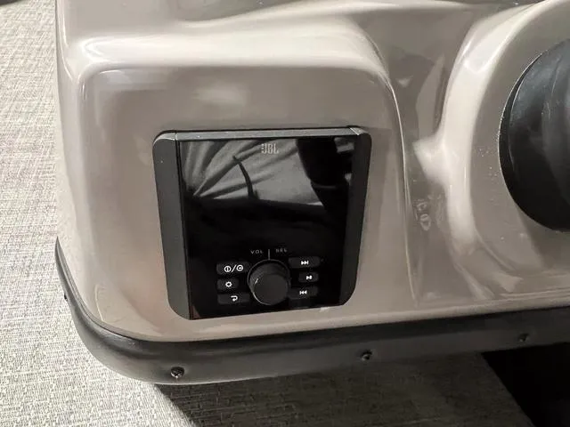 Slide: The Image of 2025 Barletta Aria A24QC boat dashboard with JBL audio control panel. - 14