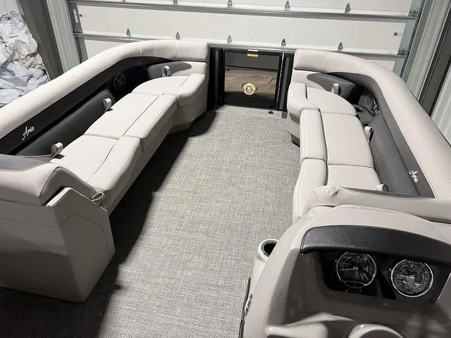 Slide: The Image of 2025 Barletta Aria A24QC boat interior with plush seating and modern design. - 19