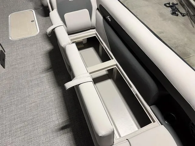 Slide: The Image of 2025 Barletta Aria A24QC boat interior with open storage compartment. - 20