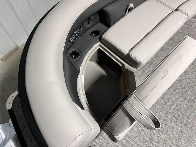 Slide: The Image of 2025 Barletta Aria A24QC boat interior with beige seating and storage compartment. - 23