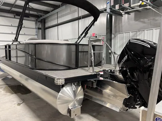 Slide: The Image of 2025 Barletta Aria A24QC pontoon boat with Mercury outboard in a storage facility. - 3