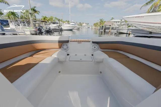 Slide: The Image of 2022 Starcraft SVX 190 DC boat interior with spacious seating in a marina setting. - 4