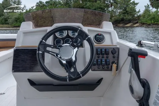 Slide: The Image of 2022 Starcraft SVX 211 OB boat dashboard with steering wheel and controls. - 4