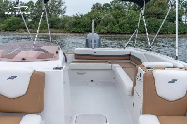 Slide: The Image of 2022 Starcraft SVX 211 OB boat interior with tan and white seating, on a calm waterway. - 8
