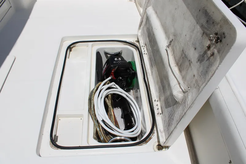 Slide: The Image of Storage compartment on a 2006 Silverton 42 Convertible boat with coiled rope and equipment. - 10