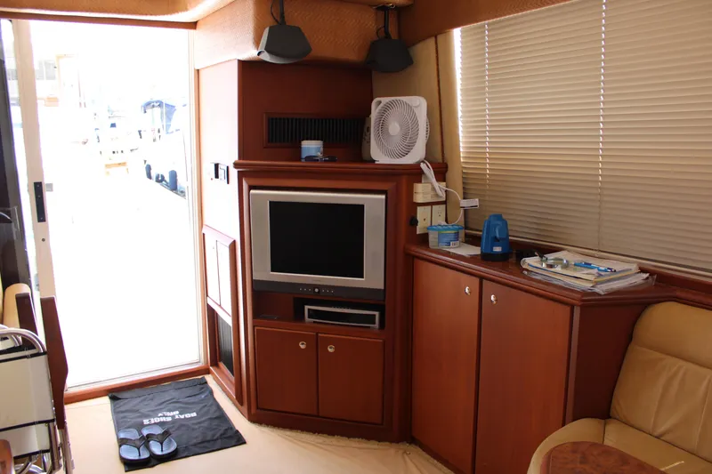 Slide: The Image of Interior of 2006 Silverton 42 Convertible yacht with TV and wooden cabinetry. - 14