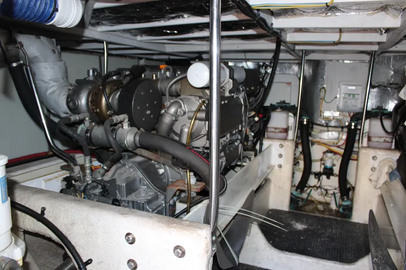Slide: The Image of Engine room of a 2006 Silverton 42 Convertible yacht, showcasing mechanical components. - 23