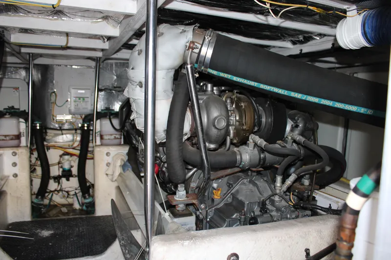 Slide: The Image of Engine room of a 2006 Silverton 42 Convertible yacht, showcasing mechanical components. - 24
