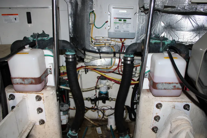 Slide: The Image of Engine room of a 2006 Silverton 42 Convertible boat, showing wiring and fluid containers. - 26