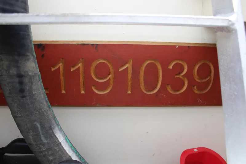 Slide: The Image of Red plaque with gold numbers 1191039 on a 2006 Silverton 42 Convertible boat. - 30
