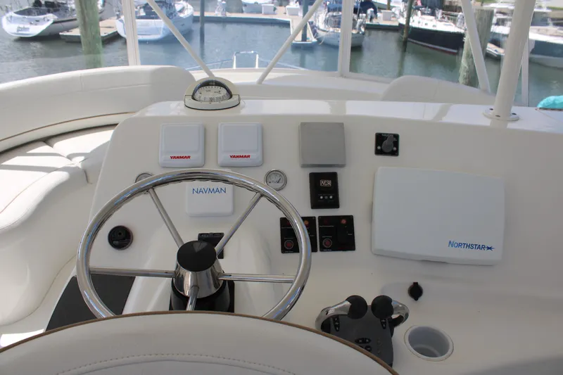 Slide: The Image of 2006 Silverton 42 Convertible yacht helm with steering wheel and navigation controls. - 32