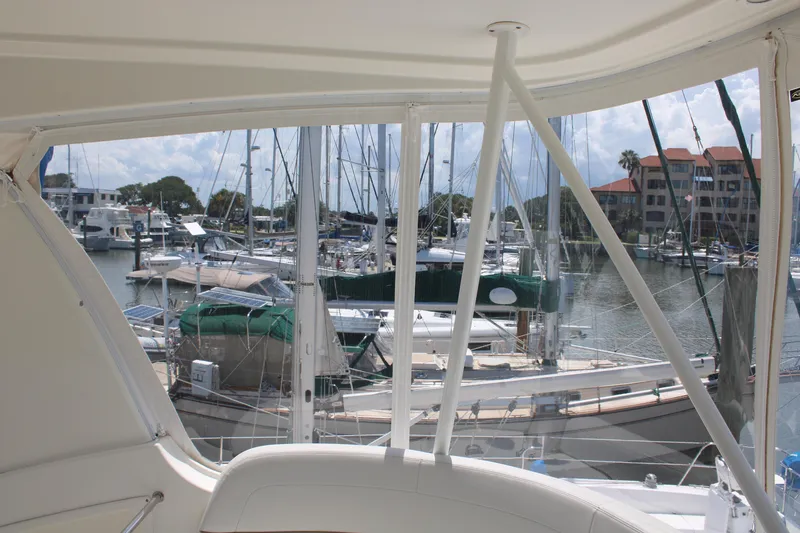 Slide: The Image of View from 2006 Silverton 42 Convertible yacht overlooking marina with sailboats and waterfront buildings. - 39