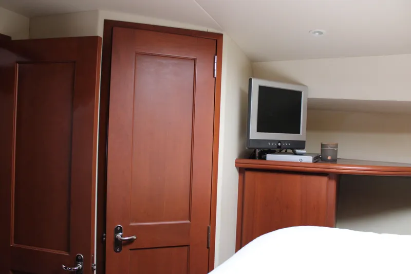 Slide: The Image of Interior of 2006 Silverton 42 Convertible yacht with wooden door and TV. - 41
